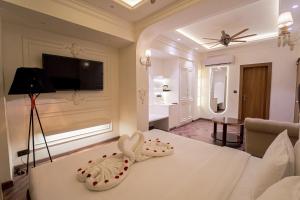 a hotel room with a bed with two hearts on it at Pink Mango A Boutique Hotel in Hisār