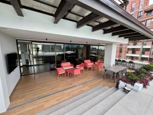 a patio with red chairs and tables on a building at Beautiful 2 Bedroom with pool in Guatemala