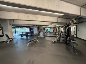 a gym with several treadmills and machines in it at Beautiful 2 Bedroom with pool in Guatemala