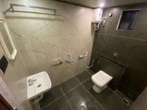 a bathroom with a toilet and a sink at Rock n Ocean2 , Beach stay in Udupi +16 photos