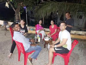 a group of people sitting around a table at Karthika Homes in Anachal