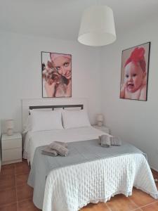 a bedroom with a bed with two pictures on the wall at HACIENDA DEL MARQUES III To Chill in Cuevas del Almanzora +52 photos