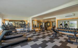 a gym with treadmills and elliptical machines at Chalston Beach Resort in Calangute