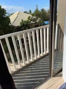 a balcony with a white railing and a window at Light 2Bedroom Loft @WVTowers#28 in Iloilo City