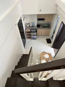 a staircase leading up to a kitchen with a table at Light 2Bedroom Loft @WVTowers#28 in Iloilo City