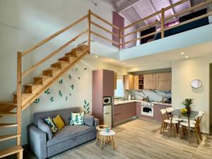 a living room with a couch and a staircase at Apidalos Apartments in Corfu