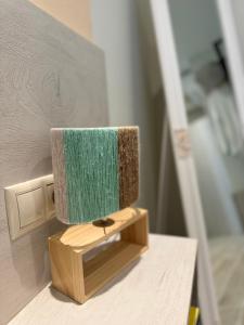 a green lamp sitting on a wooden table at Apidalos Apartments in Corfu +62 photos