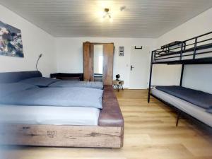 a bedroom with two beds and a bunk bed at Alp-Juwel mit Pool und Sauna für Familien und Hunde ideal in Missen-Wilhams