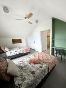 sypialnia z 2 łóżkami i biurkiem w obiekcie Melody w mieście Saint-Paul