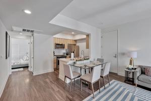 a kitchen and living room with a table and chairs at 3 Lux large apartment heart of SM in Los Angeles