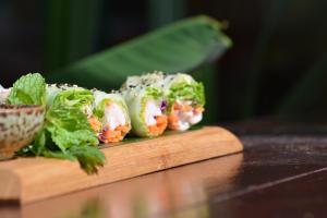 a pile of sushi on a wooden cutting board at Surfescape Fuerteventura in Lajares