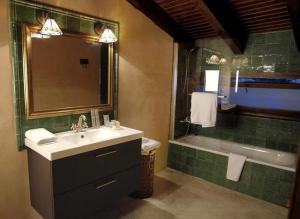 a bathroom with a sink and a bath tub at La Premsa Hotel Rural in Cardona