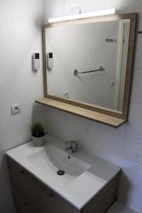 a bathroom with a white sink and a mirror at Résidence Les Chaumettes - 2 Pièces pour 6 Personnes 124 in Le Dévoluy