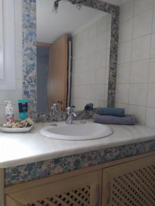 a bathroom counter with a sink and a mirror at SUN GARDEN in Skala Sotiros +25 photos