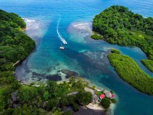 an island with a boat in the water at Hostal Portobelo in Portobelo