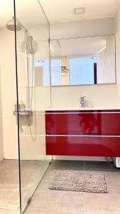 a bathroom with a red sink and a mirror at Sukhumvit13 Luxury suite in Bangkok