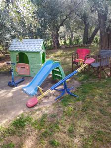 a playground with a slide and a bench at SUN GARDEN in Skala Sotiros