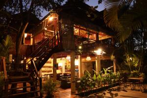 a tree house with a staircase leading up to it at Sambor Village Hotel in Kompong Thom