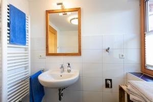 a bathroom with a sink and a mirror at Zum Hecher Klausi in Wackersberg