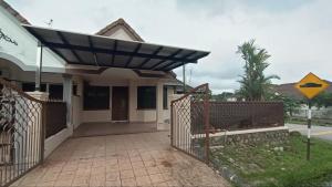 a house with awning on the front of it at Rinting Corner Islamic Homestay, Pasir Gudang in Masai