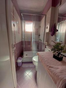 a bathroom with a shower and a toilet and a sink at Central Comfort Apartment 5 Minute Walk to Beach, Free Parking, 2 BR in Struga