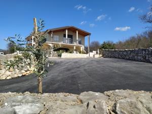 a house with a driveway in front of it at Apartmani Suzana in Crikvenica