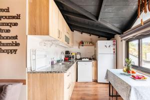 a kitchen with a white refrigerator and a counter at Arya Roof House in Marmaris