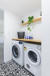 a laundry room with a washer and dryer at Unit 4 @ Tropical Reef Apartments in Port Douglas