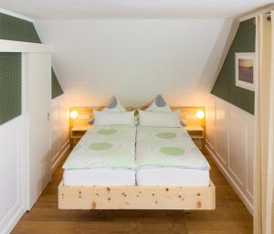 a small bedroom with a bed in a attic at Sonnenhof Damnatz -Hotel garni- in Damnatz +58 photos