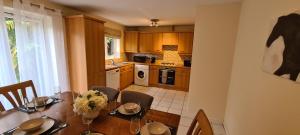 a kitchen with a table with chairs and a dining room at Vyna Place-Close to City Hospital in Nottingham