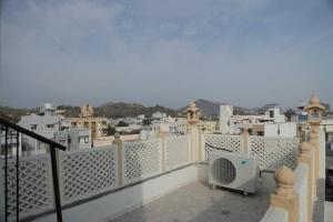 a balcony with a view of a city at Gulmohar Homes in Udaipur