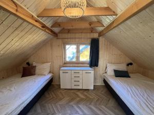 two beds in the attic of a tiny house at Holiday house in Pobierowo for 8 people near the sea in Pobierowo