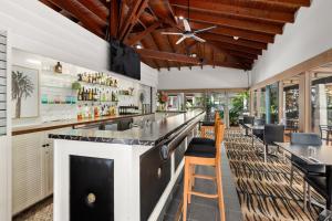 a bar in a restaurant with a counter and chairs at Zebra Motel in Coffs Harbour