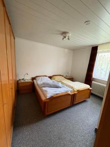 a small bedroom with a bed and a window at Ewald von Holten in Bremerhaven