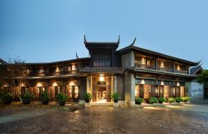 an asian style house with a lit up facade at Lijiang Ancient City Anyu Hotel in Lijiang
