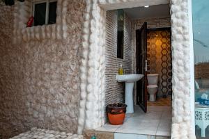 a bathroom with a sink and a toilet at Elegant Garden & 2Living Areas, 2 Bed Rooms for 6 Guests in Umm al ‘Amad