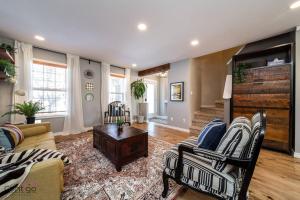 a living room with a couch and a table at Stylish Euro Vibes Home, Small Gym, AC, Yard, Office in Edmonton