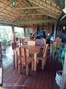 a wooden table and chairs on a wooden deck at Leopards and Louries Bush Lodge in Camperdown