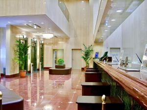 a lobby of a building with potted plants at Yonago Universal Hotel in Yonago