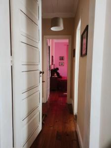 an empty hallway with a pink door and a room at Real Santo António Guest House in Tarouca +53 photos