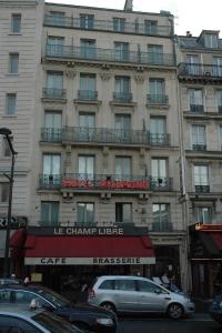 パリにあるホテル リッチモンド ガル デュ ノールの車が通りを通った建物