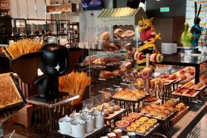 a buffet with various pastries and other food on display at Crowne Plaza Zhengzhou High Tech Zone, an IHG Hotel in Zhengzhou