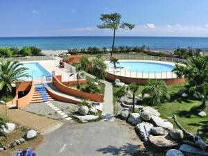 a swimming pool with the ocean in the background at Lovely apartment in Borgo with shared pool in Borgo