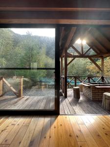 a view from a glass door of a wooden deck at MARUTA 和歌山すさみ in Susami