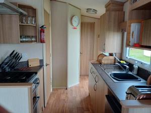 a kitchen with a sink and a counter top at 20 in Trelaske