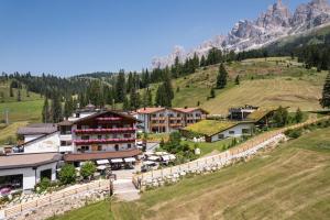 an aerial view of a resort in the mountains at Moseralm Dolomiti Spa Resort in Nova Levante