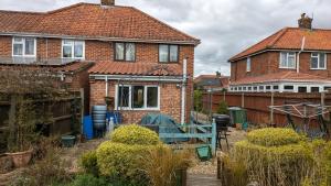a house with a garden in front of it at Relaxing 3 Bedroom Norwich Haven in Norwich
