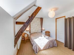 a bedroom with a bed with a table and chairs at Welcoming Holiday Home in Brainville with Fenced Garden in Brainville