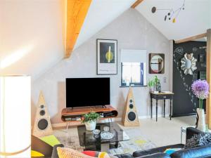 a living room with a flat screen tv and speakers at Premium apartment in Saint Quirin with garden in Saint-Quirin