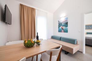 a living room with a table and a couch at Apartments Medena in Trogir